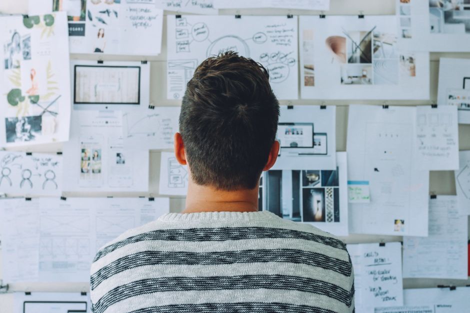 Man staring at brainstorming board for making decisions and thinking