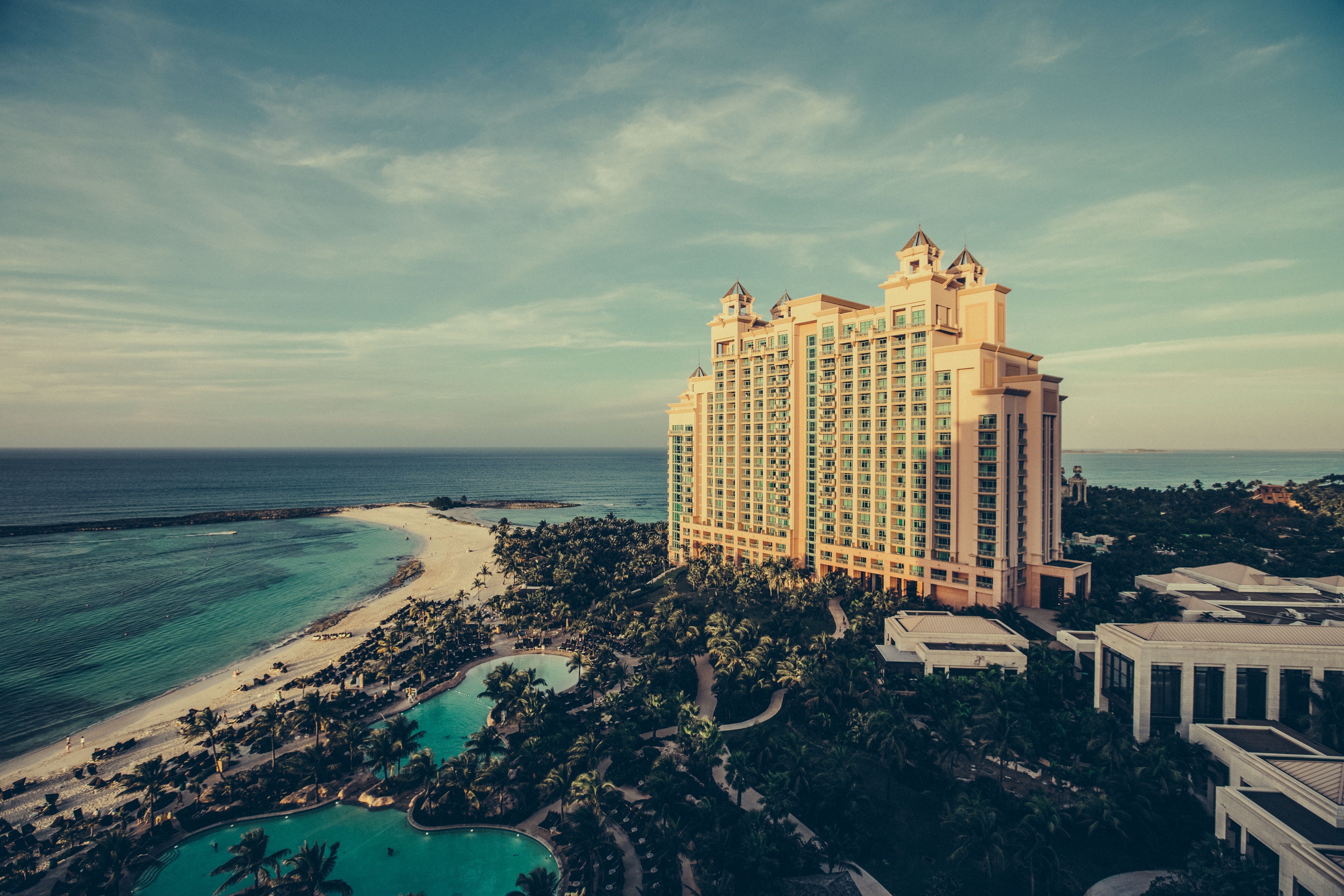 Landscape image of a luxurious holiday resort situated on a picturesque beach front.