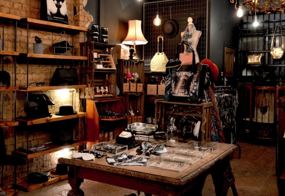 An image of a fashion store interior with a variety of garments and accessories neatly presented.