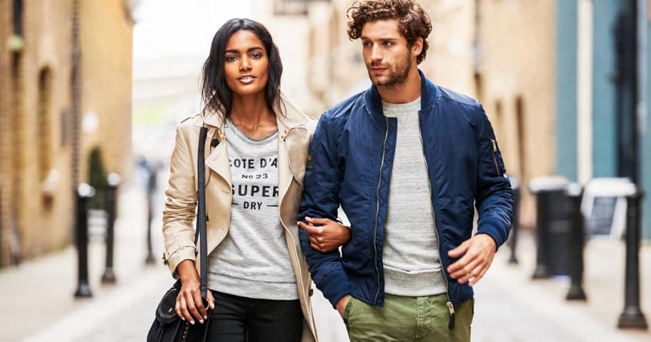 Man and Woman walking down street in Superdry clothing