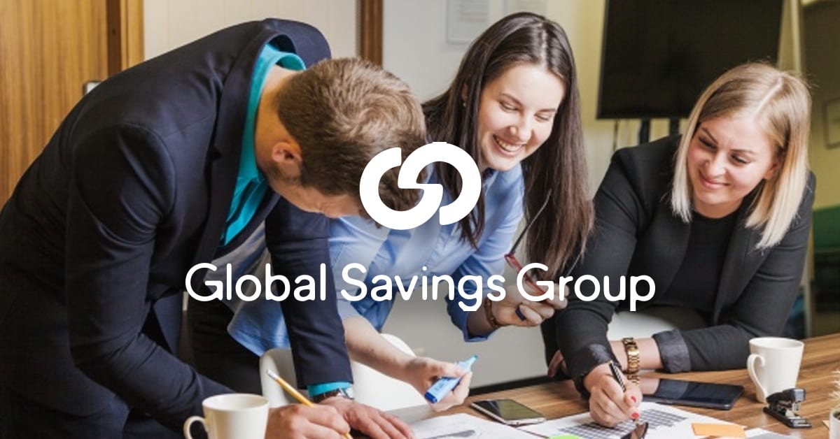 People sat a table drawing on a piece of paper with the Global Savings group logo overlaid on top.